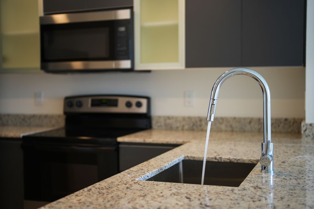Water running from a kitchen faucet in a Mesa home